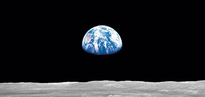Earthrise.  Image taken from the Apollo 14 Spacecraft, showing the bright Earth, in a dense black 'sky', rising above the pale surface of the Moon.  Click here to go to NASA's Earth from Space WebSite.